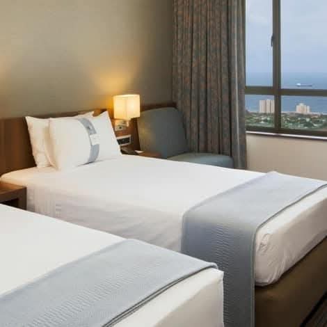 Hotel room interior with sea view from bed
